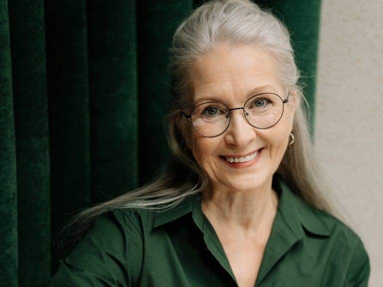 Symbolbild Frau im mittleren Alter mit Alterssichtigkeit.