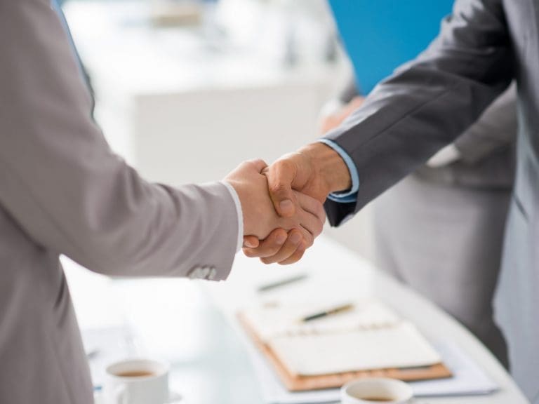 Hands of business people shaking hands after successful meeting