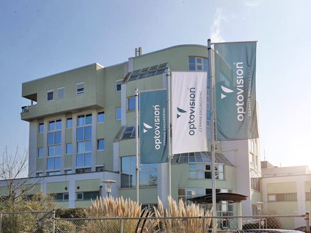 Optovision-Werk in Langen (Hessen) von außen mit wehenden Fahnen
