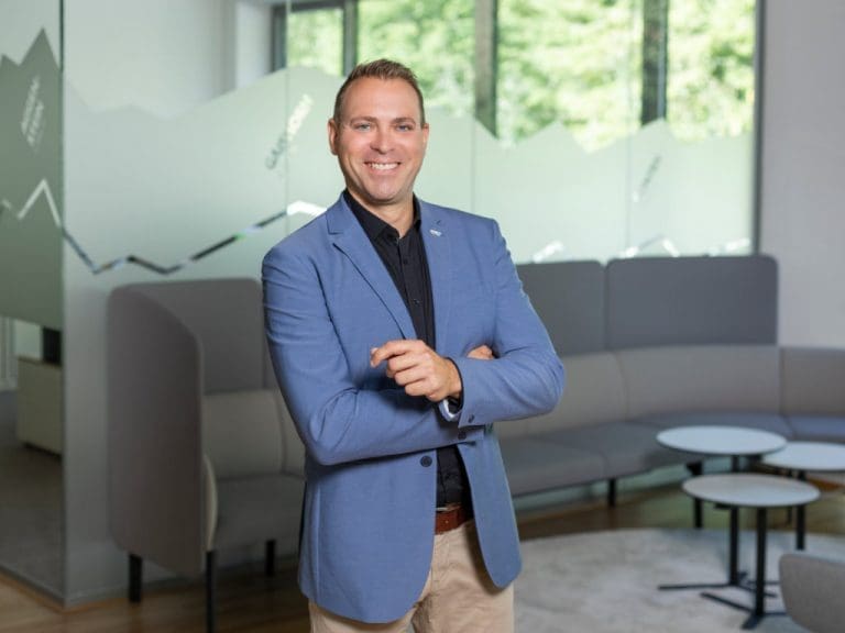 Brillen-Profi-Unternehmensberater Gerd Philipp Ruiner steht vor einer Sitzgruppe in einem Seminarraum